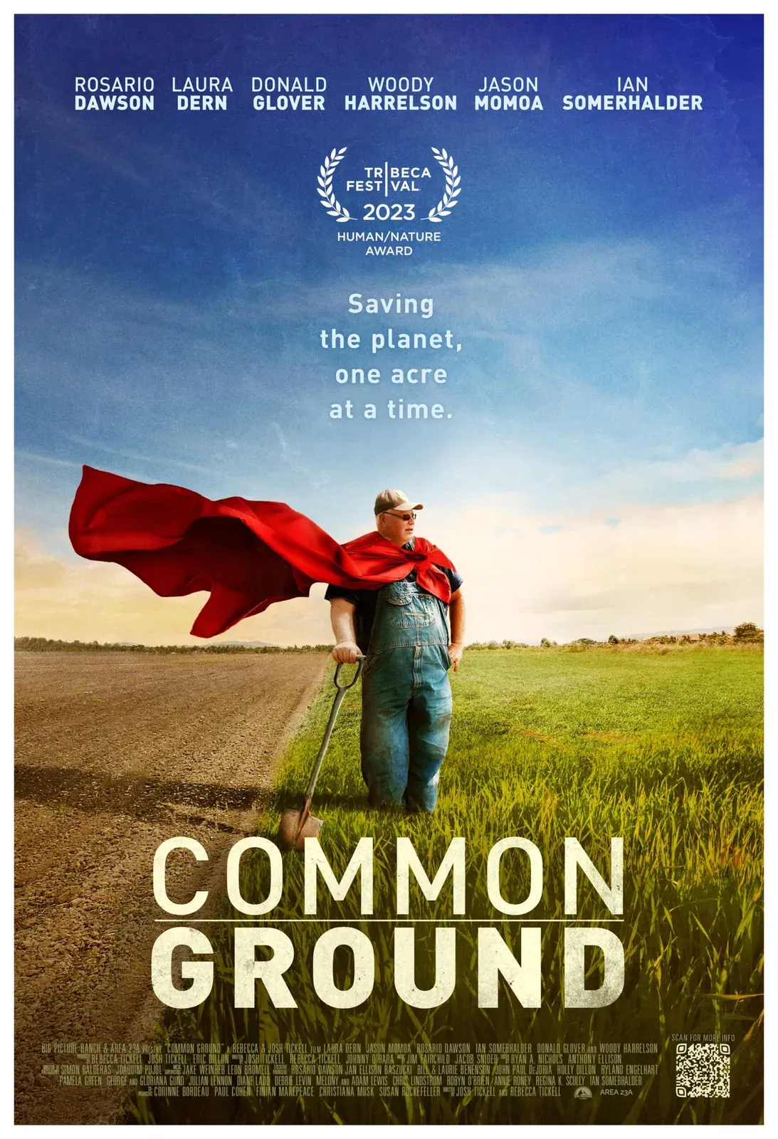 Common Ground (2023): Official theatrical poster for Common Ground: a farmer in overalls and a flowing red cape leaning on a shovel at the line between bare tilled soil and green crop.