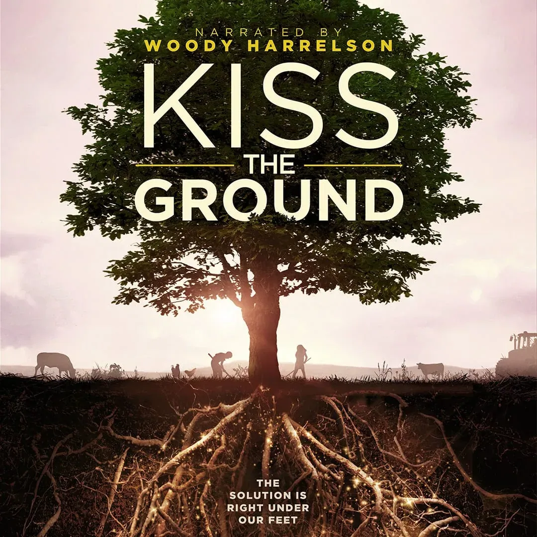 Kiss the Ground (2020): Square version of the official Kiss the Ground poster: a backlit tree with glowing roots spreading underground and silhouetted farmers and animals at ground level.