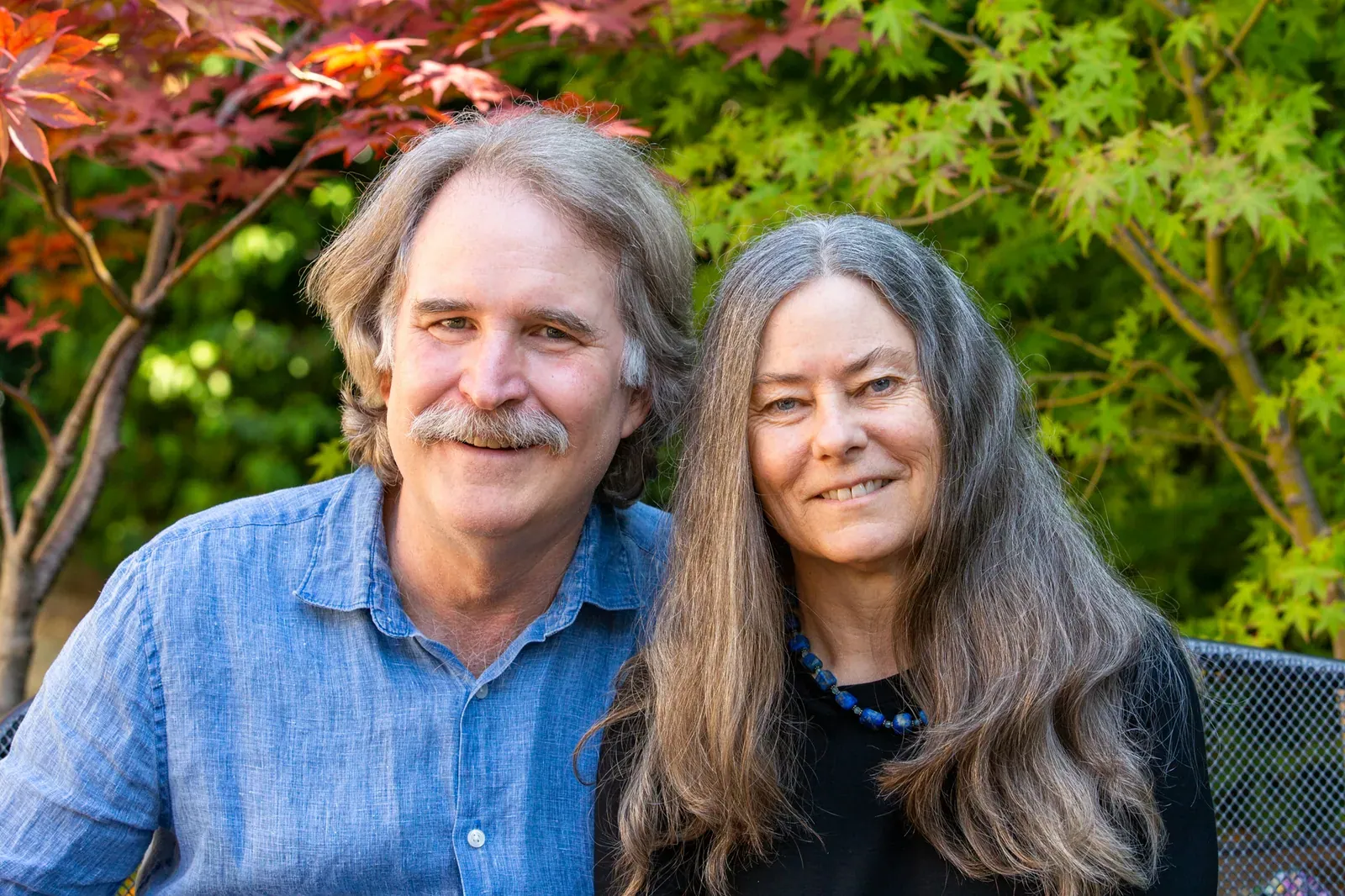 David R. Montgomery and Anne Biklé: David R. Montgomery and Anne Biklé side by side in their garden in front of Japanese maples.