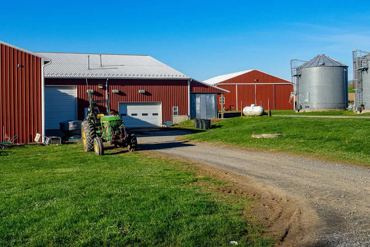 Rodale Institute Blog: Red barns, a tractor and grain silos on the Rodale Institute farm in Kutztown, Pennsylvania, from the institute's press assets library (file credited to Kent Fairfield; library instructions say credit Rodale Institute).