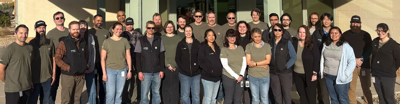 Heliae (PhycoTerra): Group photo of the Heliae team standing in front of their building (very wide 1920x500 banner).